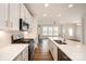 Gourmet kitchen featuring stainless steel appliances, white cabinets, and a central island at 604 Amalfi Dr, Davidson, NC 28036