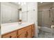 Bathroom boasts a vanity with wood cabinets, shower/tub combo, and tiled flooring at 606 Elmhurst Dr, Fort Mill, SC 29715