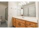 Bright bathroom with wood cabinets, a large mirror, and shower/tub combo at 606 Elmhurst Dr, Fort Mill, SC 29715