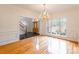 Bright dining room hardwood floors, chandelier, and view of entryway at 606 Elmhurst Dr, Fort Mill, SC 29715