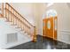 Two-story foyer with granite floors, wooden staircase, and elegant door at 606 Elmhurst Dr, Fort Mill, SC 29715