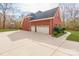 Three-car garage with attached driveway and brick exterior at 606 Elmhurst Dr, Fort Mill, SC 29715