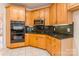 Kitchen features wood cabinets, granite countertops, and stainless steel appliances at 606 Elmhurst Dr, Fort Mill, SC 29715