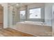 Luxurious bathroom featuring a soaking tub with shower and tiled surround at 6911 Fauna Dr # 60, Charlotte, NC 28215