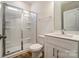 Clean bathroom with a stand-up shower with glass doors, toilet, vanity and plenty of lighting at 6911 Fauna Dr # 60, Charlotte, NC 28215