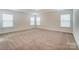 Large carpeted bedroom featuring three windows for natural light at 6911 Fauna Dr # 60, Charlotte, NC 28215