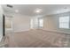 Spacious bedroom featuring neutral carpeting, natural light, and a large walk-in closet at 6911 Fauna Dr # 60, Charlotte, NC 28215