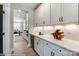 Butlers pantry with white cabinets and wine rack at 6911 Fauna Dr # 60, Charlotte, NC 28215