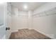 Walk-in closet featuring wire shelving, carpet flooring, and ample storage space at 6911 Fauna Dr # 60, Charlotte, NC 28215