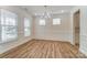 An empty dining room is painted white with hardwood floors, a chandelier and has modern paneling at 6911 Fauna Dr # 60, Charlotte, NC 28215