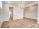 A dining room is painted white with hardwood floors and has modern paneling and openings to other rooms at 6911 Fauna Dr # 60, Charlotte, NC 28215