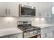 Close-up view of modern stainless steel microwave and gas range in kitchen at 6911 Fauna Dr # 60, Charlotte, NC 28215