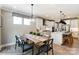 Eat-in kitchen with white cabinets, wood table, and pendant lights at 6911 Fauna Dr # 60, Charlotte, NC 28215