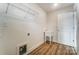 Well-lit laundry room with utility sink and wood-look flooring at 6911 Fauna Dr # 60, Charlotte, NC 28215