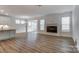 Open-concept living space with wood floors, fireplace, and natural light at 6911 Fauna Dr # 60, Charlotte, NC 28215