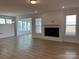 Open living room with a fireplace, shiplap accent wall and hardwood floors at 6911 Fauna Dr # 60, Charlotte, NC 28215