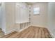 Mudroom with built-in bench, coat hooks, shelves for storage, and plenty of light from the exterior at 6911 Fauna Dr # 60, Charlotte, NC 28215