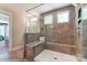 Large walk-in shower with built-in seat and gray tile at 6911 Fauna Dr # 60, Charlotte, NC 28215