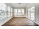 Bright sunroom featuring wood floors, three large windows and glass sliding doors to bring in natural light at 6911 Fauna Dr # 60, Charlotte, NC 28215