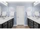 Double vanity bathroom with dark cabinetry and neutral walls at 7405 Bosson Sw St, Concord, NC 28025