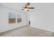 Well-lit bedroom with two windows and carpet flooring at 7405 Bosson Sw St, Concord, NC 28025