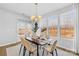 Sunlit dining area with a wooden table and chairs, access to backyard at 7405 Bosson Sw St, Concord, NC 28025