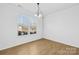 Simple dining room with hardwood floors and large windows at 7405 Bosson Sw St, Concord, NC 28025