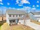 Two-story house with stone accents, three-car garage, and landscaped yard at 7405 Bosson Sw St, Concord, NC 28025