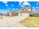 Two-story home featuring stone accents, a three-car garage, and a driveway at 7405 Bosson Sw St, Concord, NC 28025