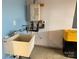 Garage utility area with sink and tankless water heater at 7405 Bosson Sw St, Concord, NC 28025