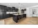 Stylish kitchen featuring dark cabinetry, granite countertops, and a large island at 7405 Bosson Sw St, Concord, NC 28025