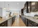 Spacious kitchen with dark cabinetry, granite countertops, and stainless steel appliances at 7405 Bosson Sw St, Concord, NC 28025