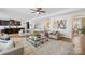 Bright and airy living room with hardwood floors and a view of the kitchen and staircase at 7405 Bosson Sw St, Concord, NC 28025