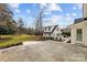 Stone patio overlooks expansive backyard with mature trees and detached garage at 835 Museum Dr, Charlotte, NC 28207