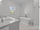 Elegant bathroom with a freestanding soaking tub and double vanity at 835 Museum Dr, Charlotte, NC 28207