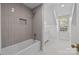 Bathroom with a shower and bathtub, grey tiled walls, and white vanity at 835 Museum Dr, Charlotte, NC 28207