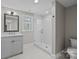 Modern bathroom with grey vanity and a glass shower at 835 Museum Dr, Charlotte, NC 28207