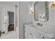 Bright bathroom with white vanity, quartz countertop, and tiled shower at 835 Museum Dr, Charlotte, NC 28207