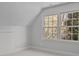 Simple bedroom with hardwood floors and large windows at 835 Museum Dr, Charlotte, NC 28207