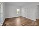 Well-lit bedroom with hardwood floors and double door closet at 835 Museum Dr, Charlotte, NC 28207