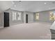 Large bonus room with neutral carpeting and multiple windows at 835 Museum Dr, Charlotte, NC 28207