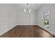 Bright dining room with hardwood floors and a modern chandelier at 835 Museum Dr, Charlotte, NC 28207