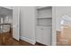 Hallway with built-in shelves and hardwood floors at 835 Museum Dr, Charlotte, NC 28207