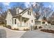 White brick home with a charming front porch and landscaped yard at 835 Museum Dr, Charlotte, NC 28207