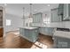 Modern kitchen with light green cabinets, quartz countertops, and large island at 835 Museum Dr, Charlotte, NC 28207