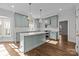 Modern kitchen with light green cabinets, quartz countertops and a large island at 835 Museum Dr, Charlotte, NC 28207