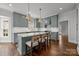 Charming kitchen featuring shaker cabinets, a kitchen island with seating, and pendant lighting at 835 Museum Dr, Charlotte, NC 28207