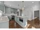 Modern kitchen with light green cabinets, quartz countertops and a large island at 835 Museum Dr, Charlotte, NC 28207