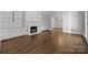 Spacious living room with hardwood floors, built-in shelving, and fireplace at 835 Museum Dr, Charlotte, NC 28207