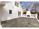 Large slate patio with built-in fireplace and French doors leading to the interior at 835 Museum Dr, Charlotte, NC 28207